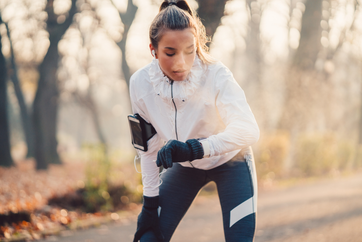 Sportswoman checking pulse stock photo