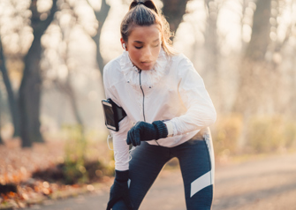 Sportswoman checking pulse stock photo