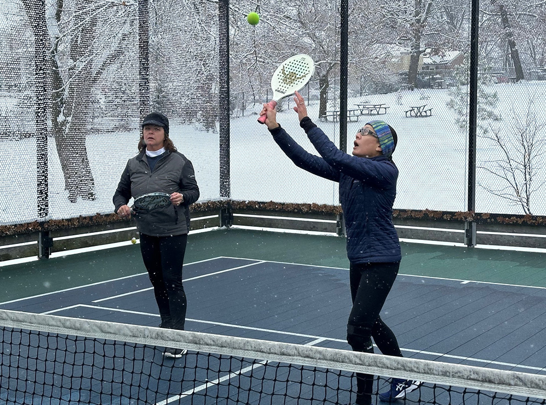 two people playing platform tennis