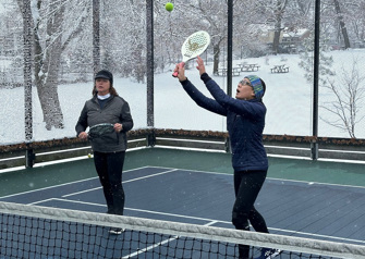 two people playing platform tennis