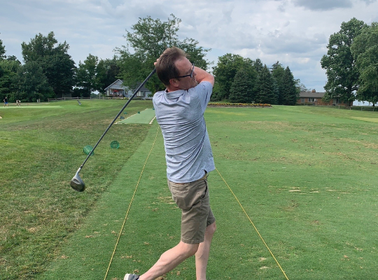 Patient Mike Bauer swinging golf club