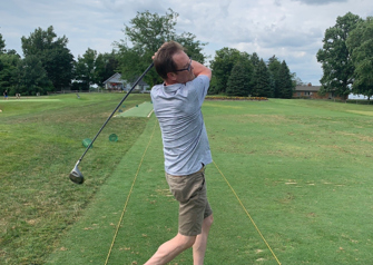 Patient Mike Bauer swinging golf club