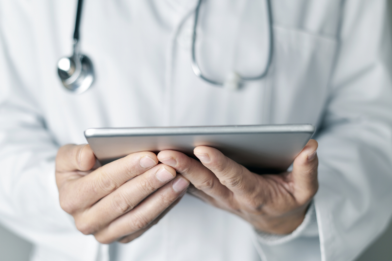 doctor using a tablet for a virtual patient visit