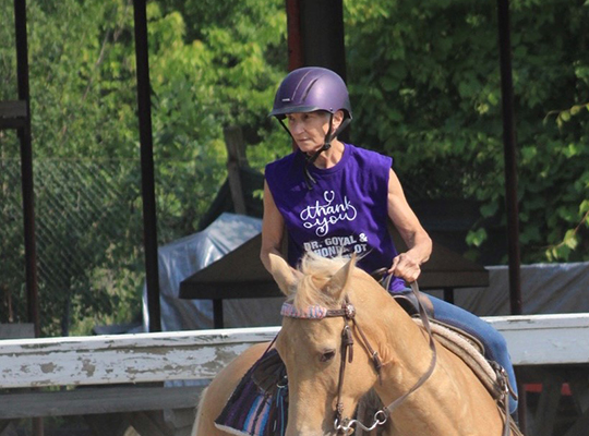 Patient Donna Marsh riding a horse