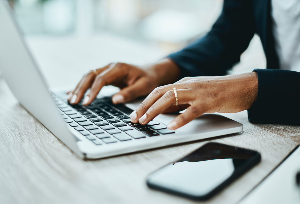 Shot of an unrecognisable businesswoman using a laptop in a modern office