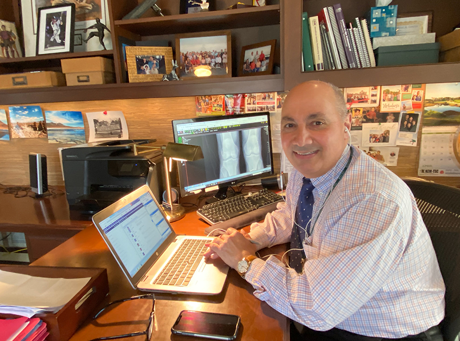 dr charles bush-joseph sitting at home office having telemedicine visits with patients