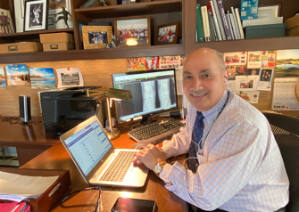 dr charles bush-joseph sitting at home office having telemedicine visits with patients