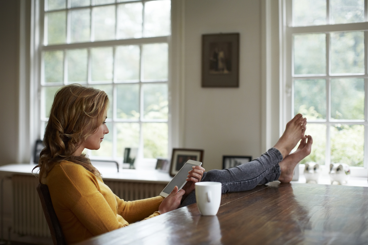 Woman relaxing barefoot with coffee