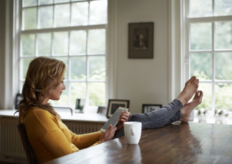 Woman relaxing barefoot with coffee