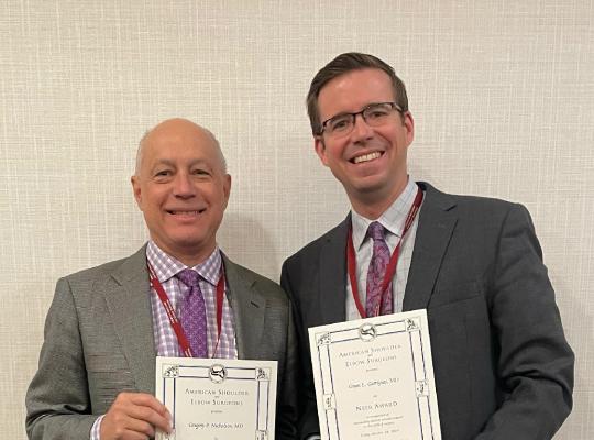 Drs. Nicholson & Garrigues with Neer Award certificate